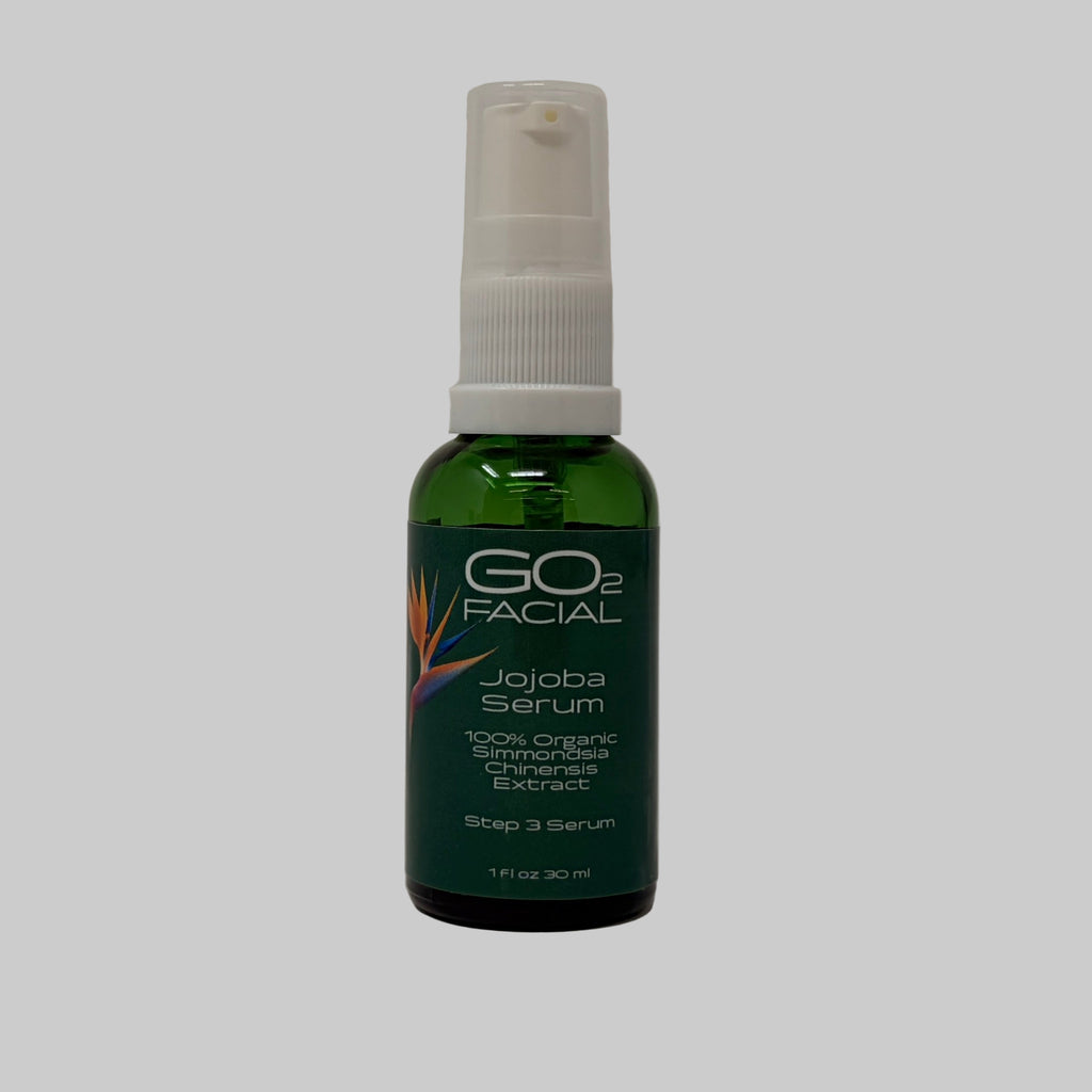 Jojoba serum bottle with white spray cap on a white background