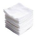 Stack of white 4x4 gauze pads on a white background